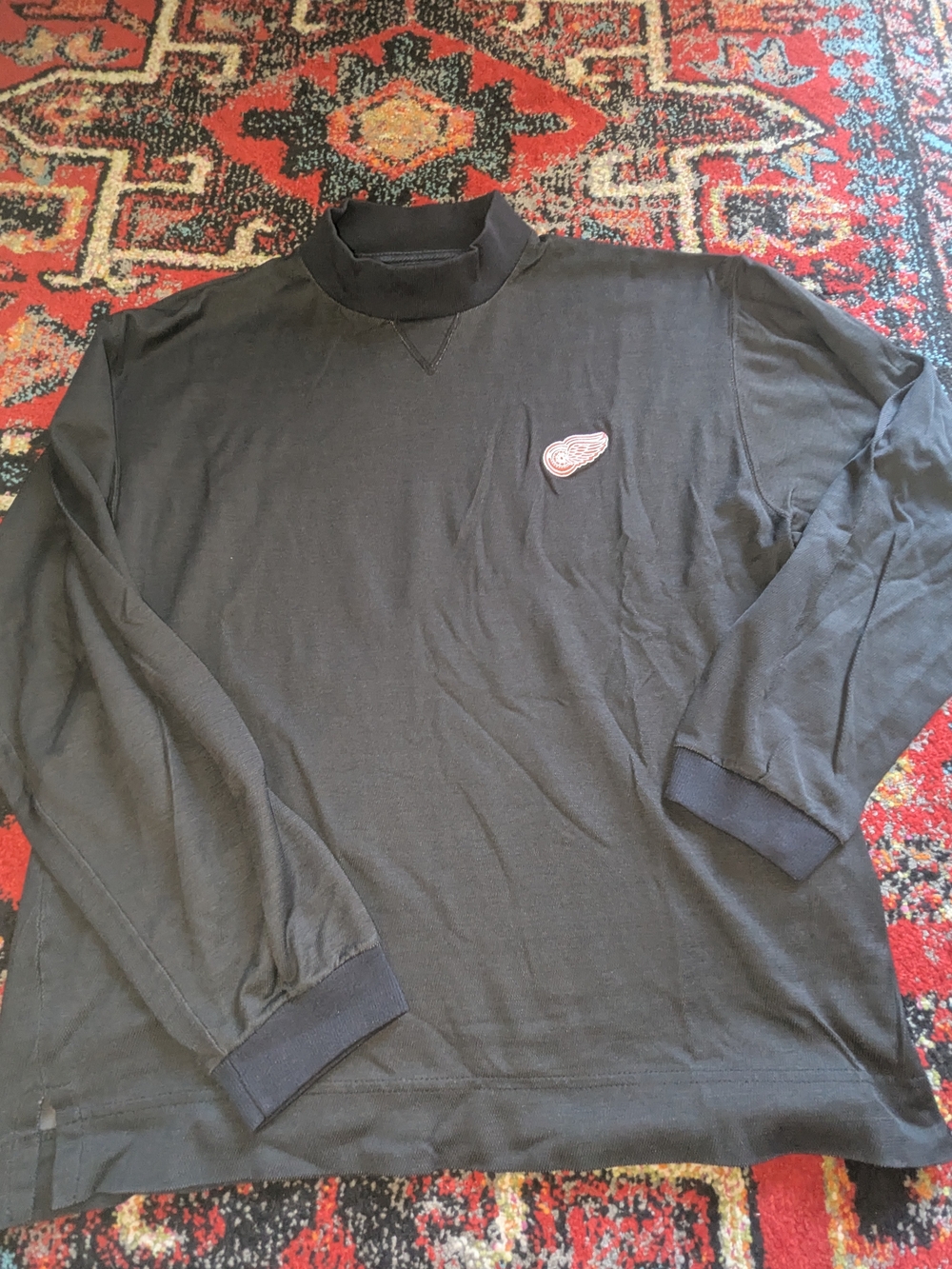 Men's Black Long-Sleeve Mock Neck Tee with Red Embroidered Wing Patch